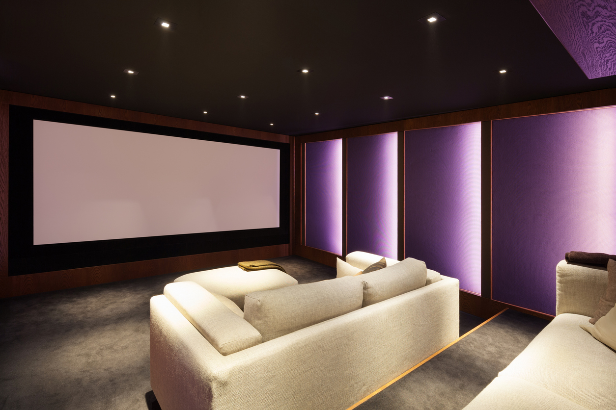 luxurious home cinema with projector screen and cream sofa