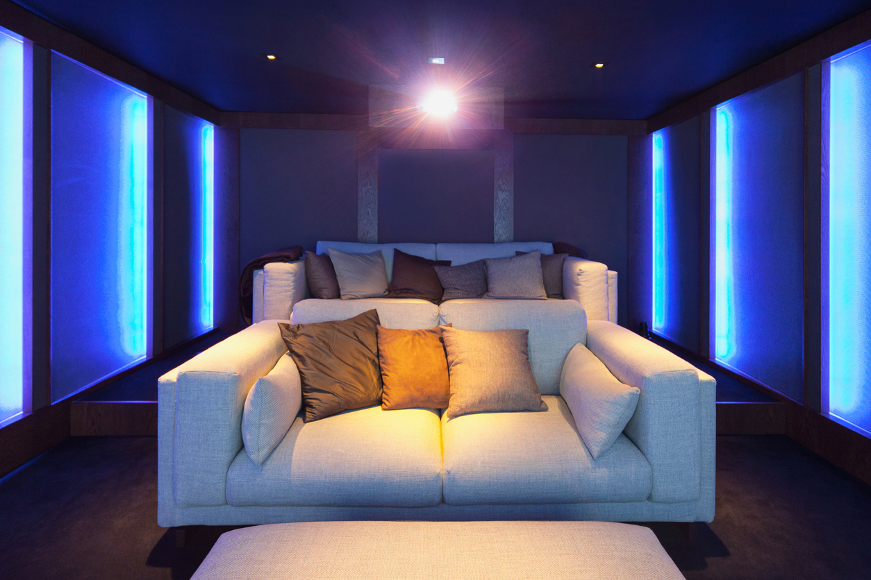 two cream sofas in cinema room at home