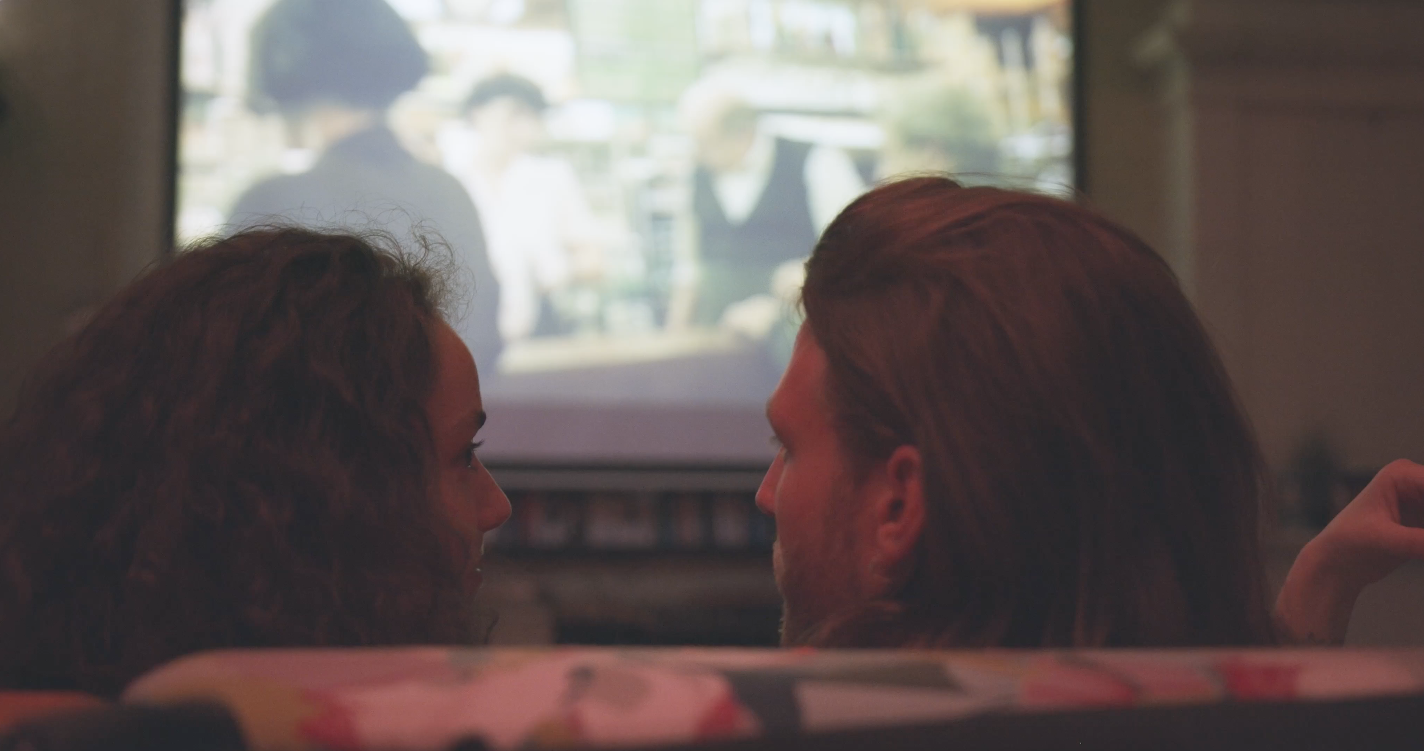 couple watching film in home cinema