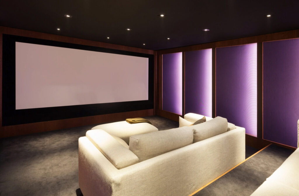 home cinema room with big screen and cream sofa