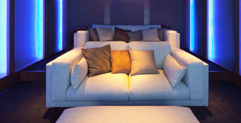 two cream sofas in home cinema room