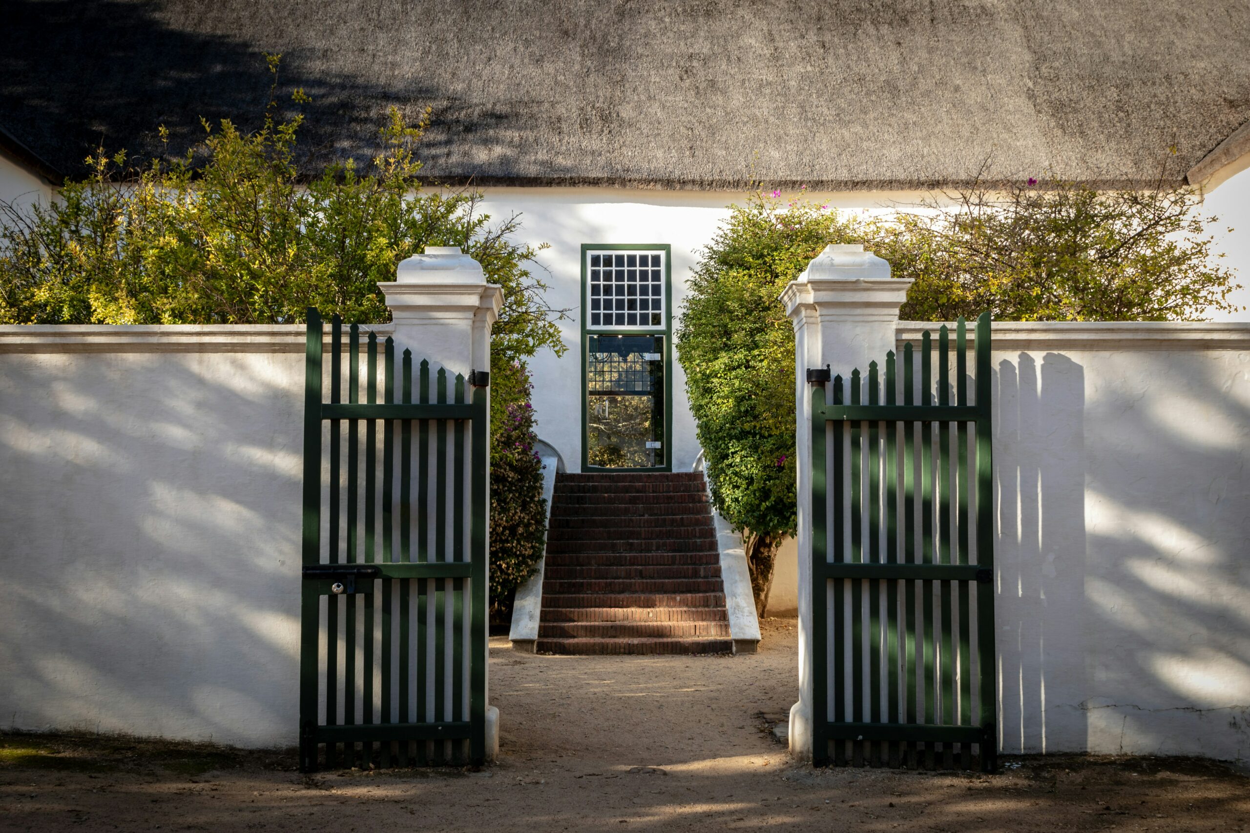 photo of house with wing gates at the front